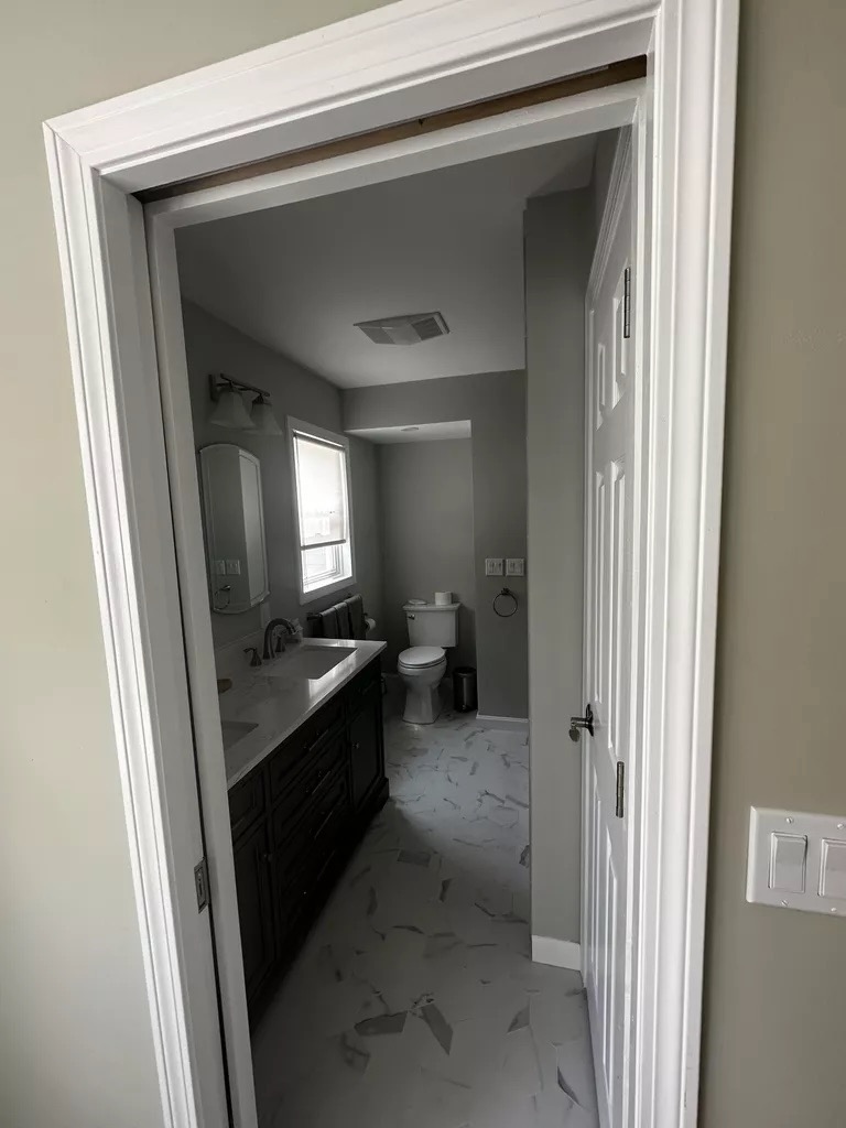 Marble tile bathroom — dark vanity and marble floor