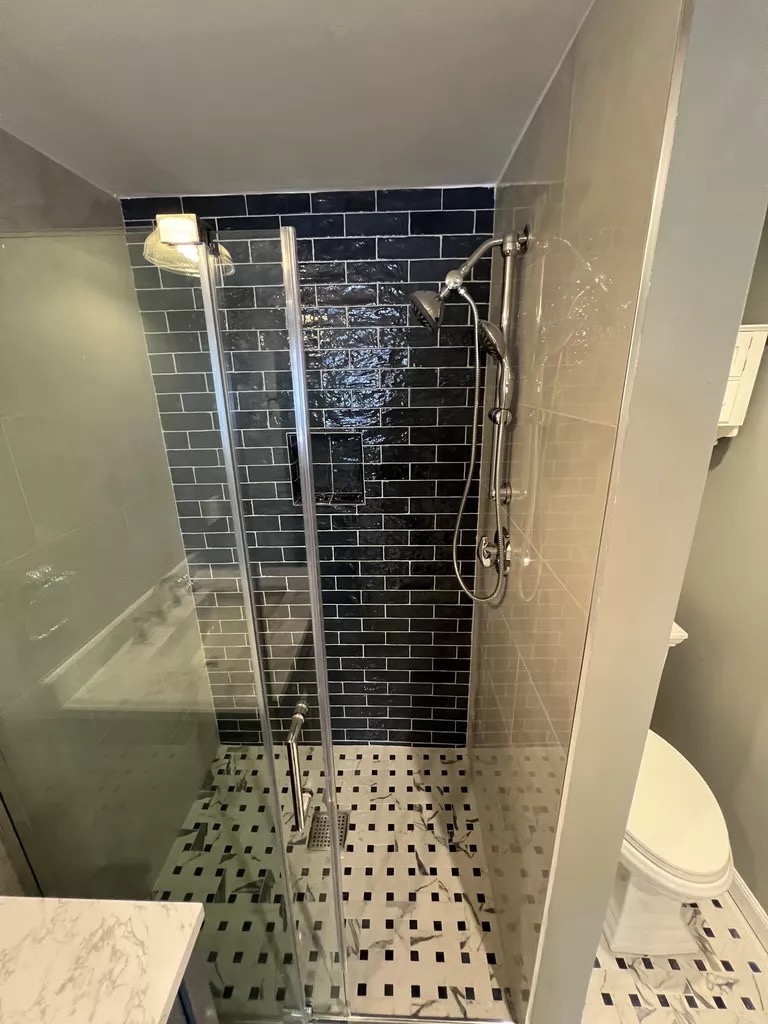 Black subway tile shower — close detail
