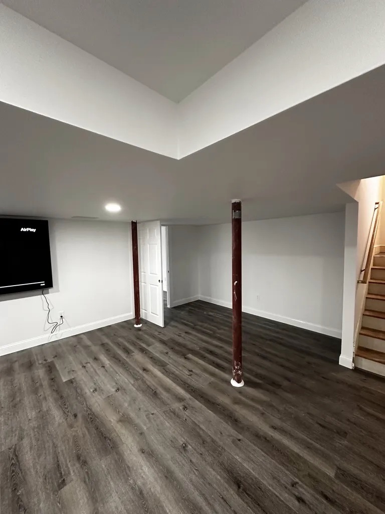 Finished rec room — full view with staircase
